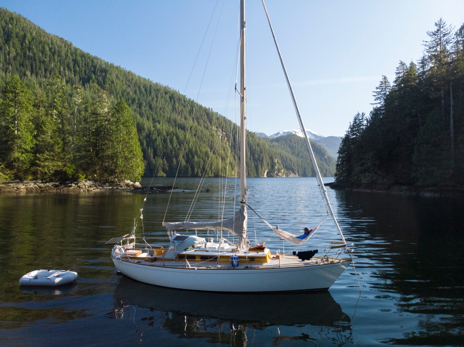 Jura at anchor beneath the mountains, a hammock slung on the foredeck