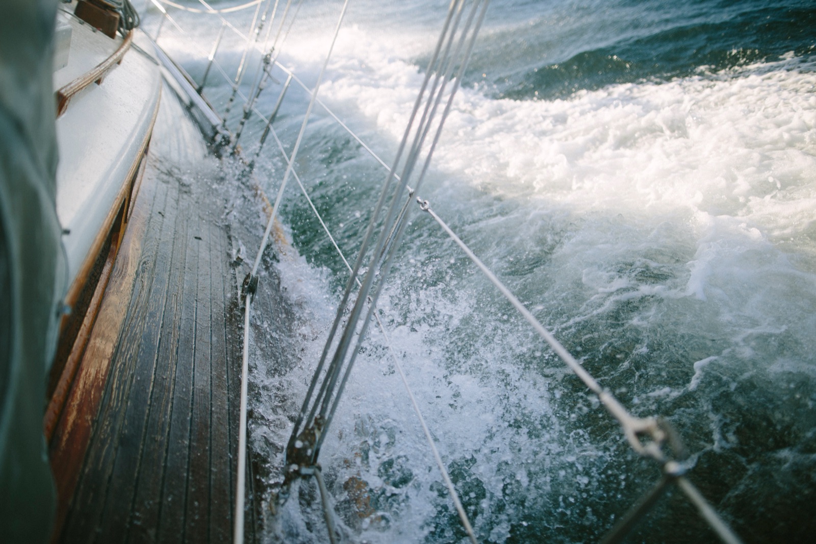 Rail down in the Strait of Juan de Fuca — water rushing along the wooden deck through the rigging